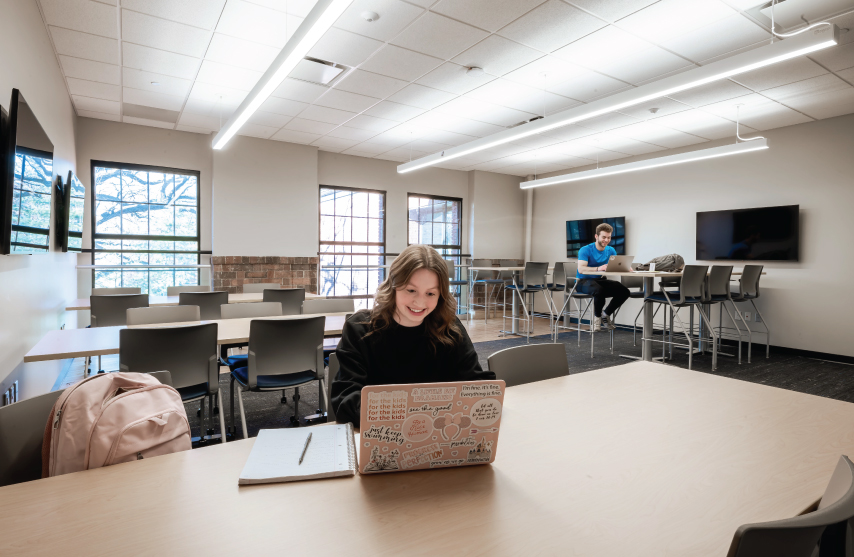 Two students studying in an empty classroom