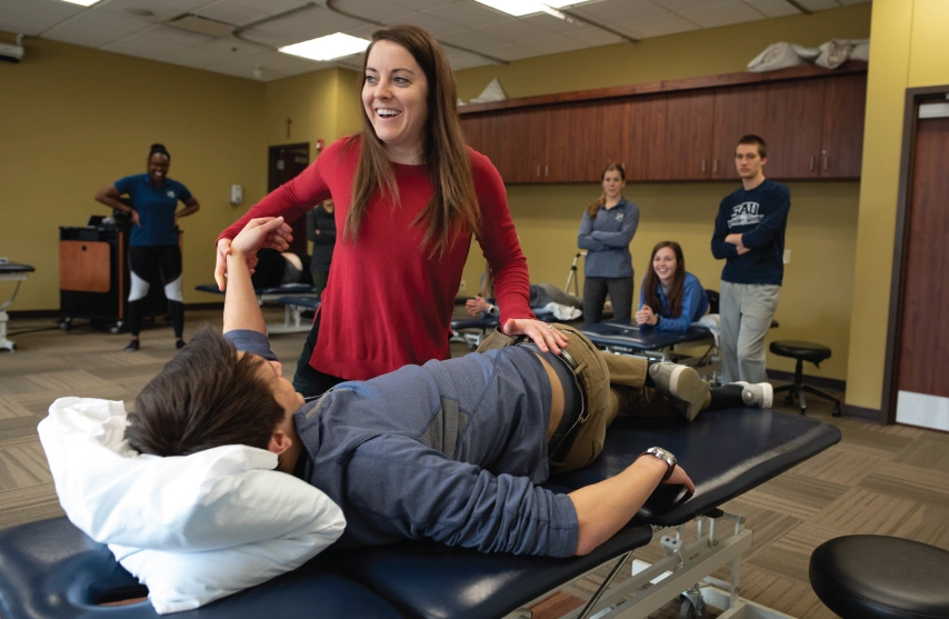 PT student practicing techniques in lab setting.