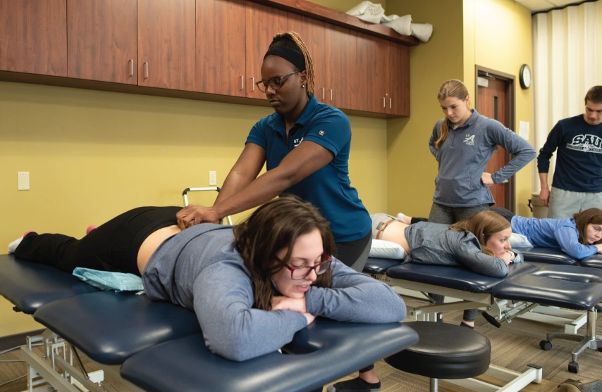 PT student practicing techniques in lab setting.