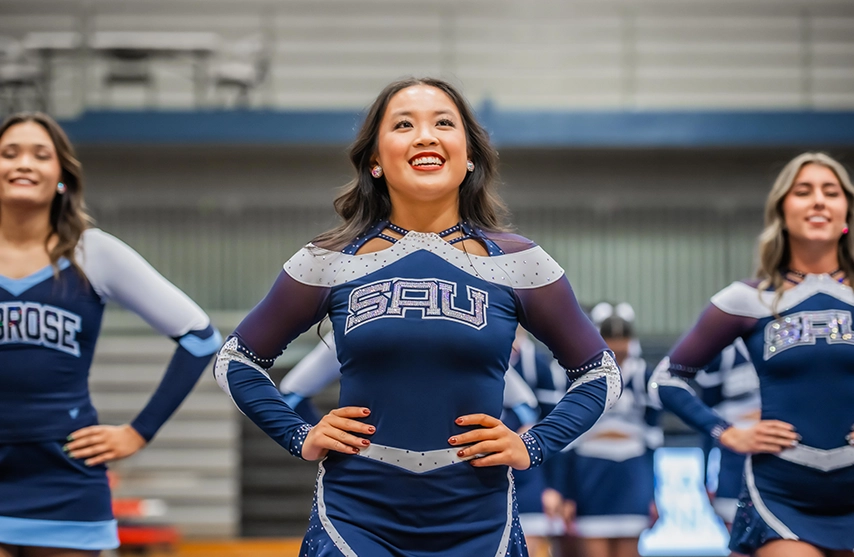 A student dance team member in the middle of a dance routine