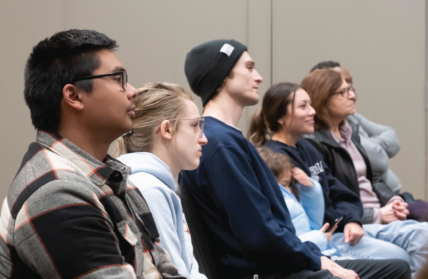 Group of students sitting in the audience at an event.