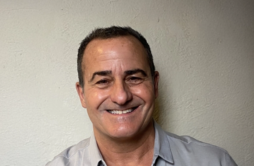 John Mondanaro smiles into the camera.