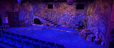 Stage made up for a show under blue and purple lights.