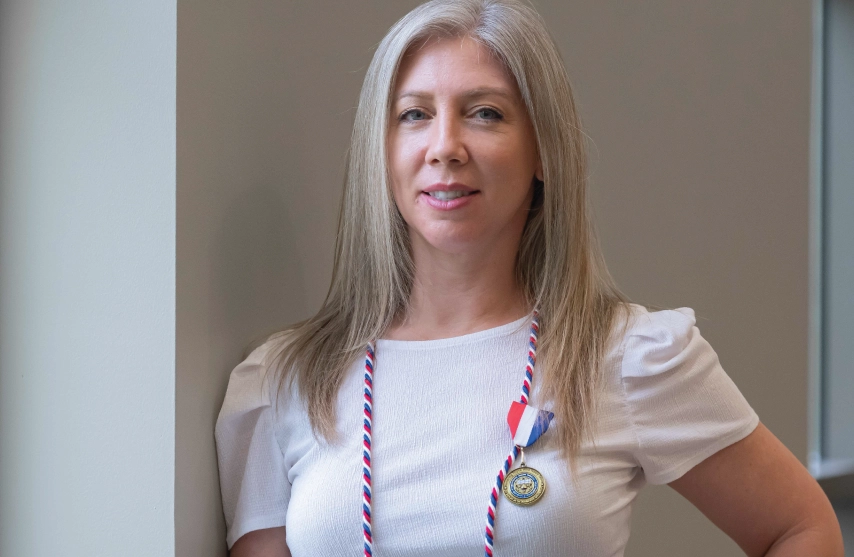 A woman wearing a medallion.