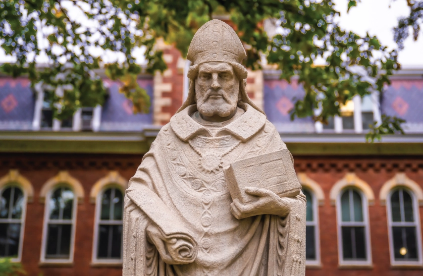 A stone statue of Saint Ambrose of Milan outside.