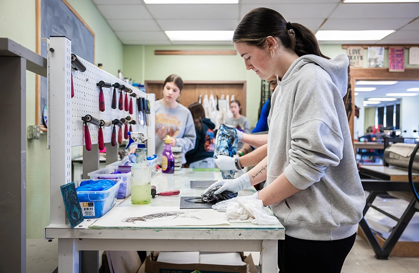 Students work on print making at St. Ambrose University while taking part in a newly launched core curriculum.