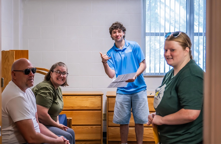 A new student and his family stand in his new dorm room at St. Ambrose University.
