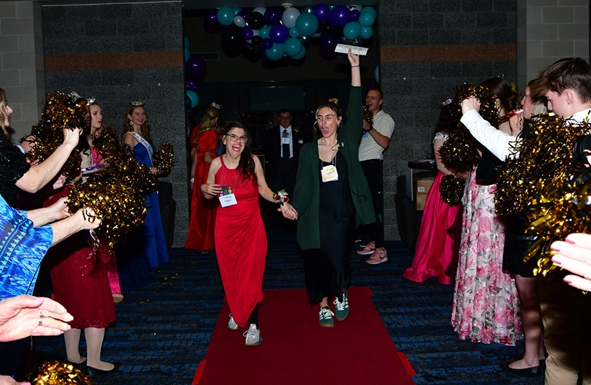 Students walk into the St. Ambrose University Rogalski Ballroom during the annual Night to Shine event.
