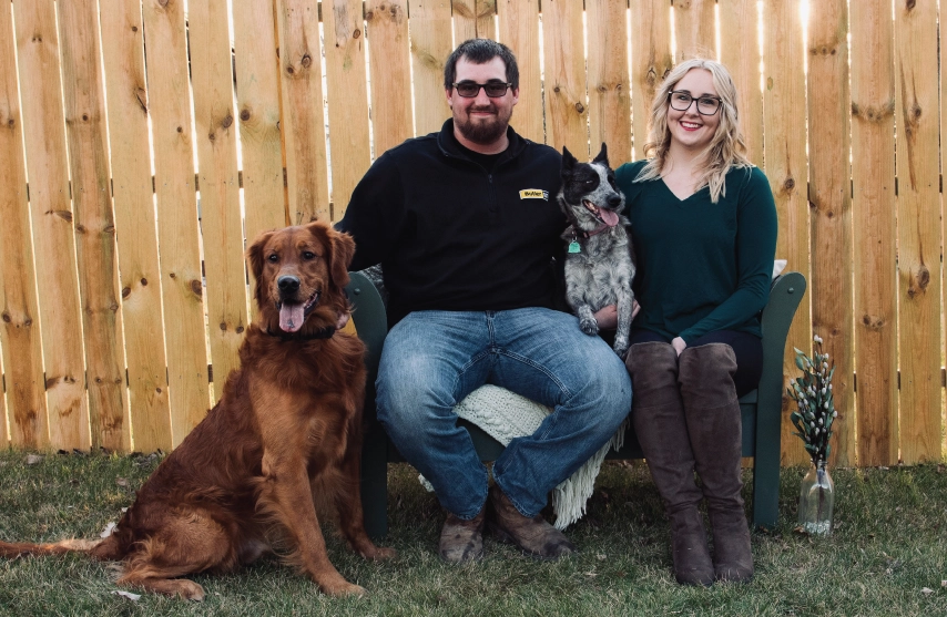 A woman with her partner and two dogs.