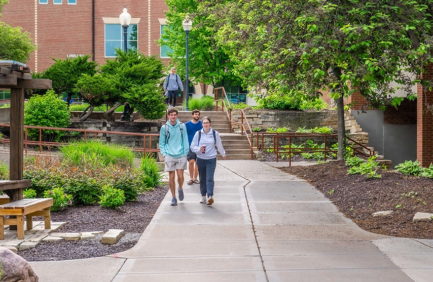 Students walk through St. Ambrose University's green space.