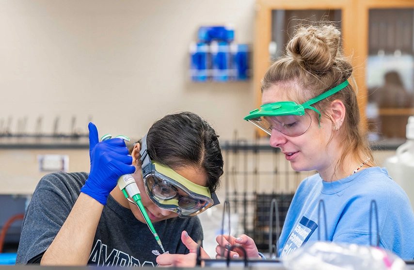 Students work with chemistry supplies to study chemical reactions.