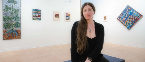 A woman sitting in an art gallery.