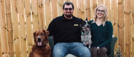 A woman with her partner and two dogs.