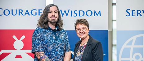 Steven McConnell and Amy Novak, PhD smile into the camera.