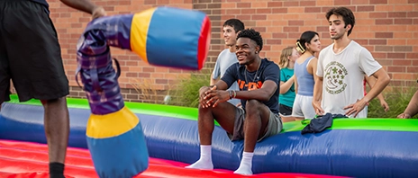 Students play on a bounce house at St. Ambrose University during a school sponsored festival.