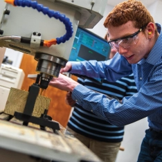 Engineering student engaged in project in lab.