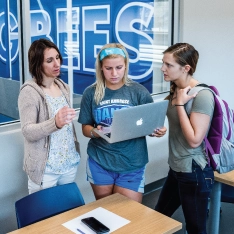 Sport management students in classroom overlooking athletic facilities.