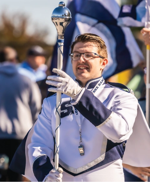 Marching band outdoors during homecoming.