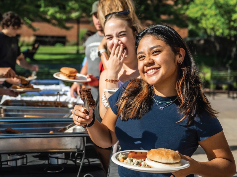 A student in line for food at and outside buffet