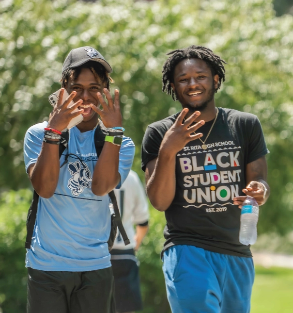 Two students walking outdoors on the first day of classes.