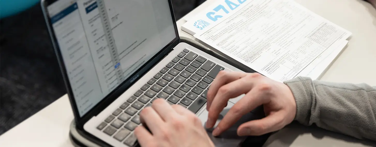 A student working on a laptop computer.