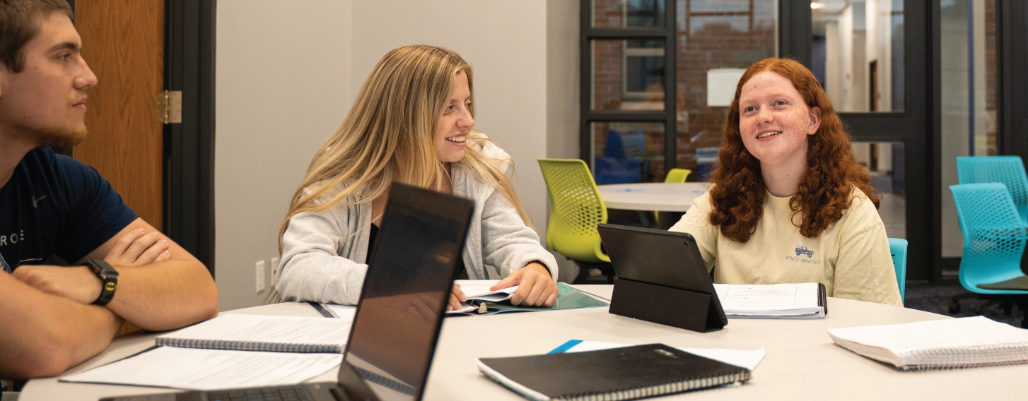 Students working together in a small group at a table.