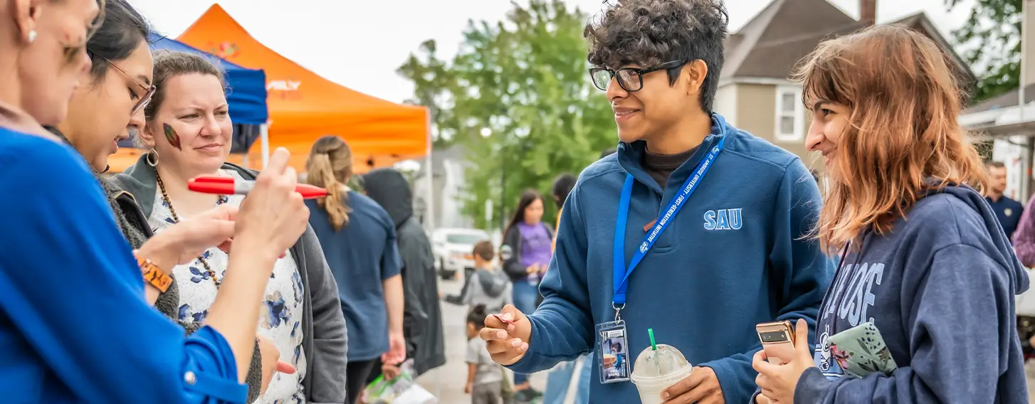 A group of people enteracting at a community event.