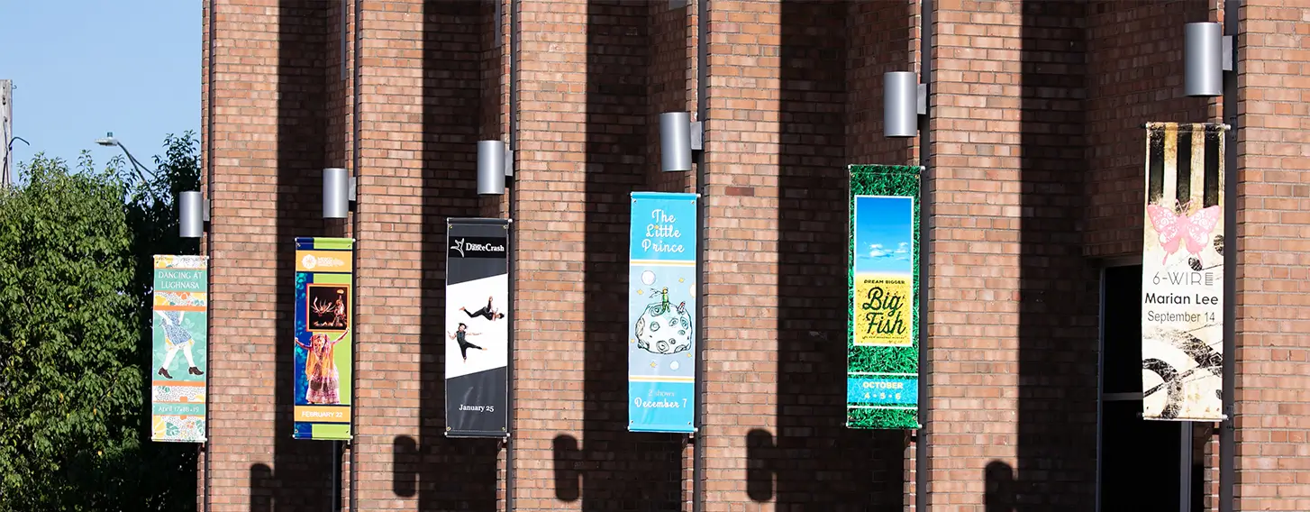 A row of signs hanging from the Galvin Fine Arts Center.