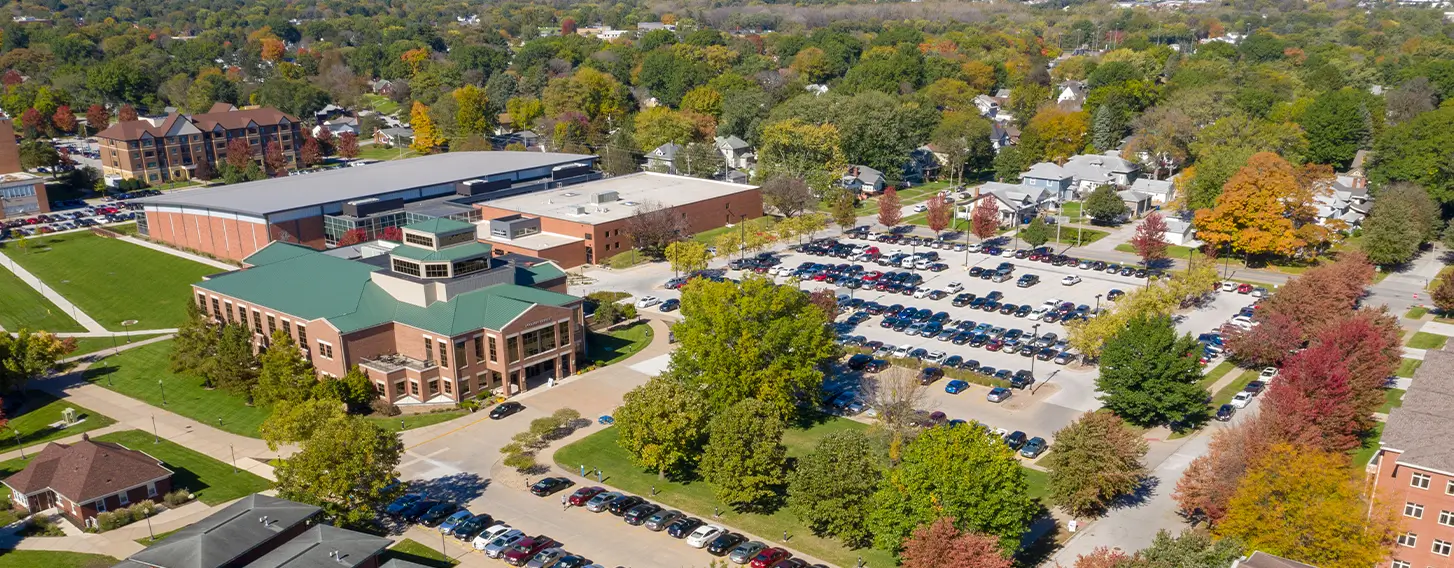 An aerial view of the campus with lush trees and buildings.