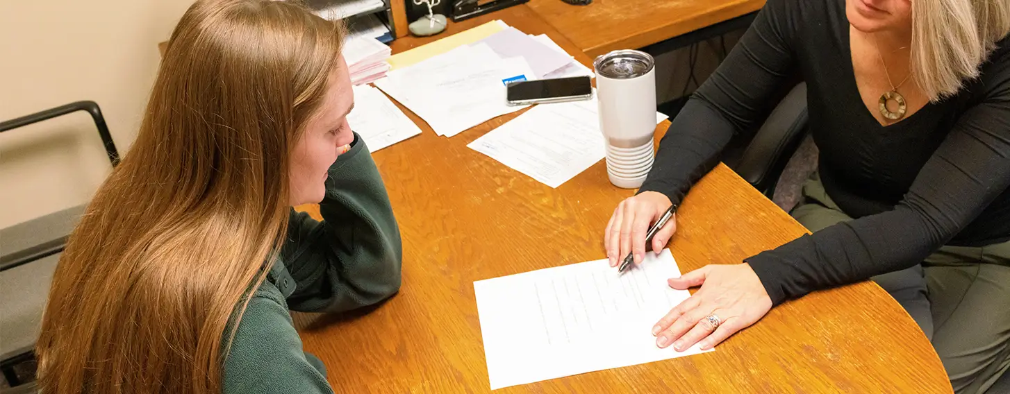 A student meeting with an advisor in an office