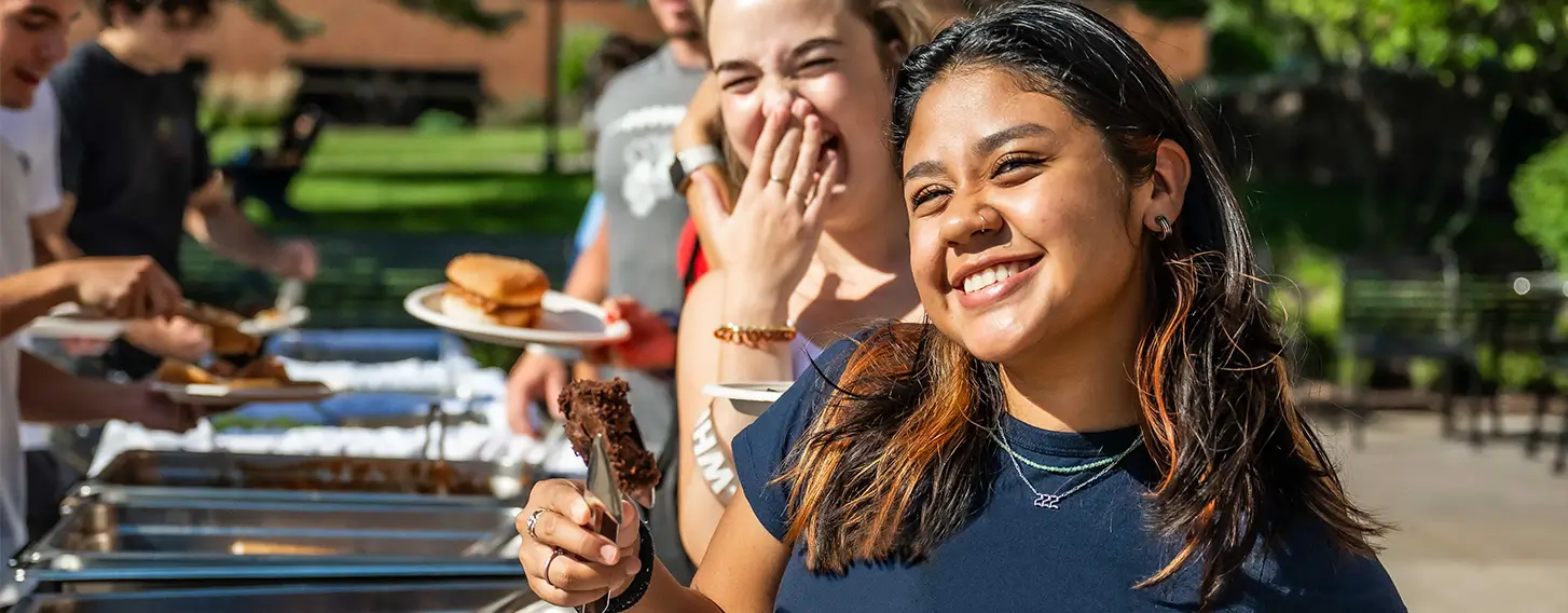 A student in line for food at and outside buffet