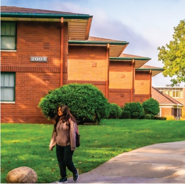 Students walking near campus townhouses in the Fall.