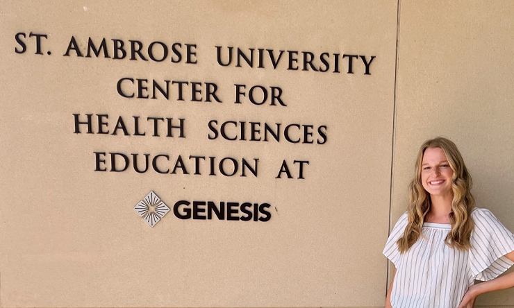 Natalie Cremer stands in front of the SAU Center for Health Sciences building