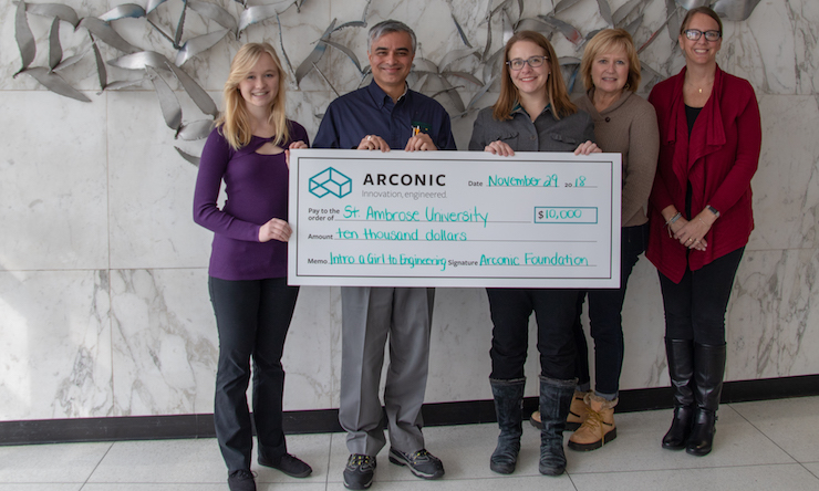 Engineering student and professor accept a check from the Arconic Foundation 