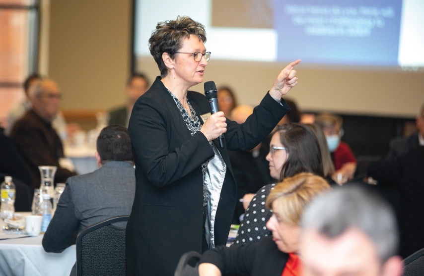 Dr. Amy Novak speaking to a group of people at an event.