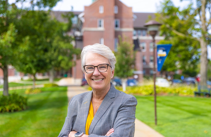 Mount Mercy Campus Board Chair LeAnn Ridgeway ’86, ’98 MBA poses outside on Mount Mercy University's campus.
