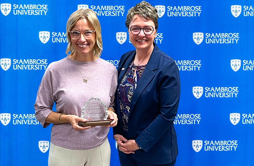 Whalen Fitzgibbon Award winner, Tammy Moran, PA-C, smiles into the camera as she stands next to St. Ambrose University President Amy C. Novak, EdD.