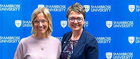 Whalen Fitzgibbon Award winner, Tammy Moran, PA-C, smiles into the camera as she stands next to St. Ambrose University President Amy C. Novak, EdD.